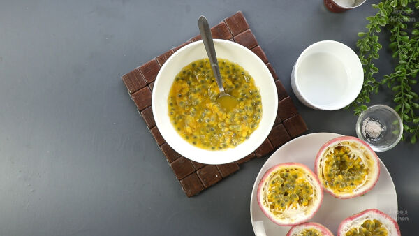 Extracting pulp from fresh passion fruits.