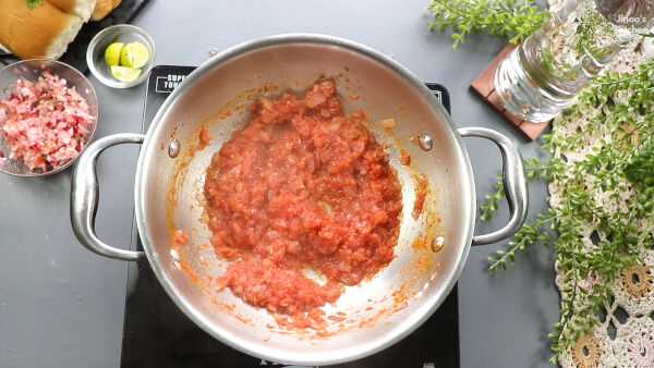 cooking the tomatoes = paneer-pav-bhaji