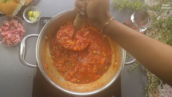 mashing the veg paneer-pav-bhaji